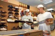 Greg Sabatino, left, and Tyler Dye check out skateboard shapes at Jet Set Surf Shop.